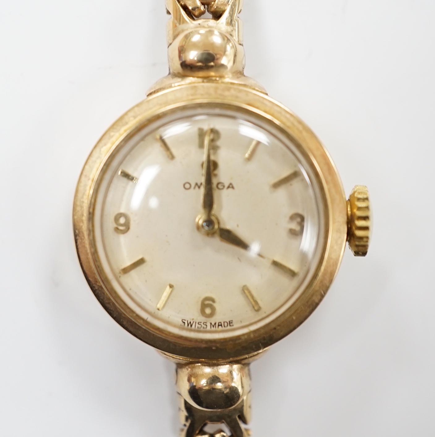 A lady's 9ct gold Omega manual wind wrist watch, on an associated 9ct gold bracelet, gross weight 17.6 grams, with Omega box.
